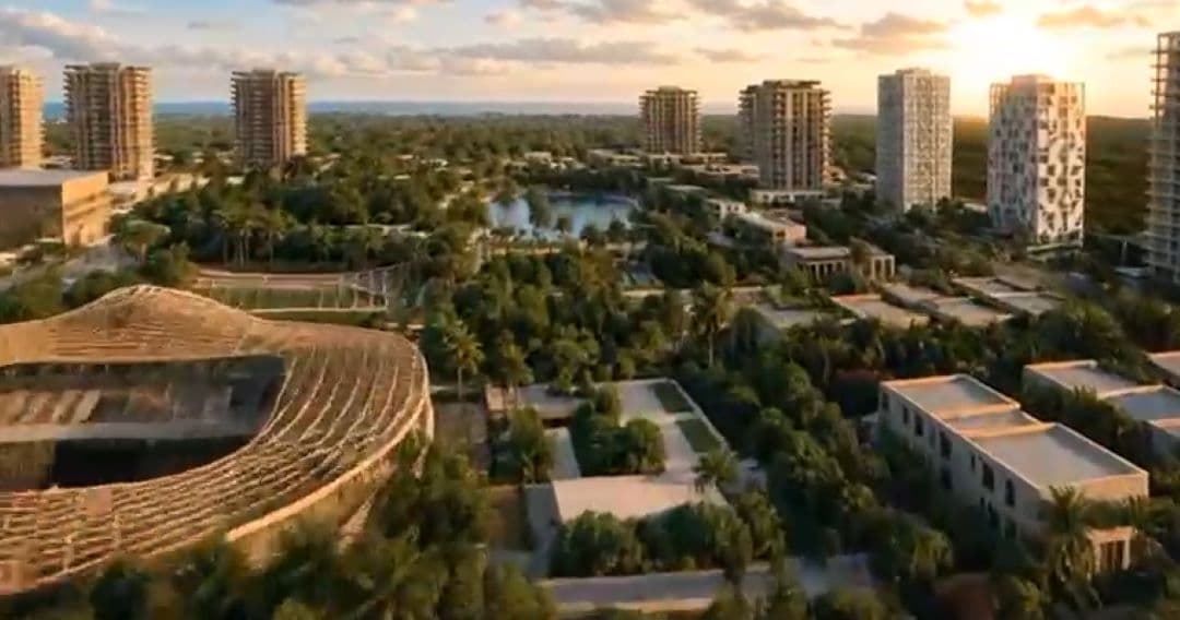 Render arquitectónico de un complejo de desarrollo urbano con torres residenciales, espacios verdes, lago artificial y edificaciones modernas al atardecer.
